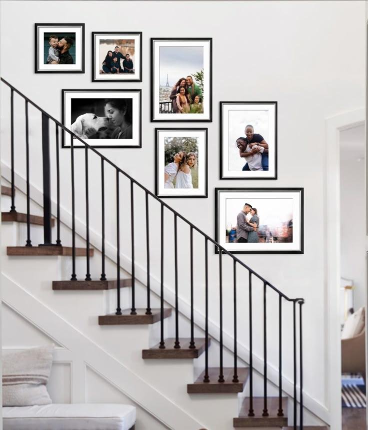 Personal family photo wall arranged elegantly beside a staircase