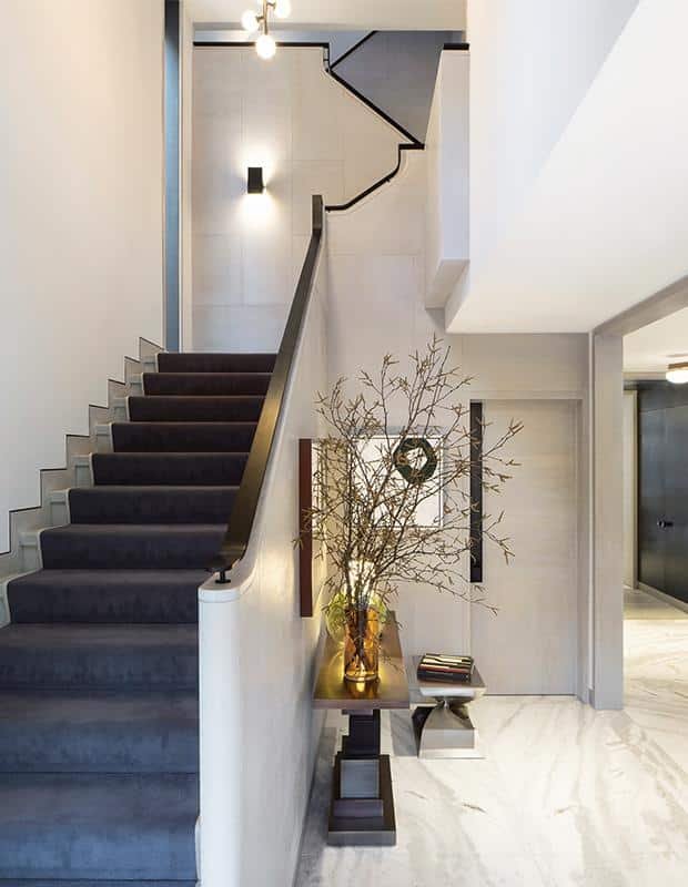 Cohesive indoor home décor connecting a modern staircase and hallway